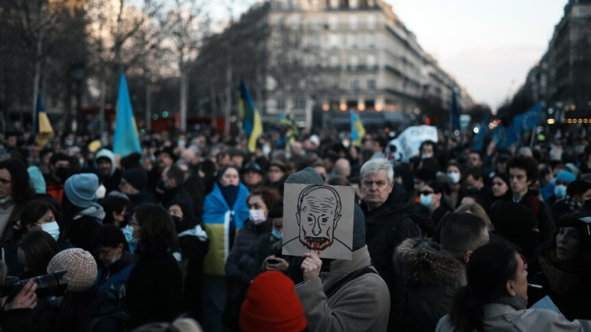 A protestor holds a placard depicting Russian President Vladimir Putin during a gathering in support of Ukrainian people, in Paris, Thursday, Feb. 24, 2022. World leaders are reacting to Russia’s invasion of Ukraine with raw outrage and vows of unprecedented sanctions that shroud a sense of powerlessness to defend Ukraine militarily without running the risk of a wider war in Europe. (AP Photo/Thibault Camus)