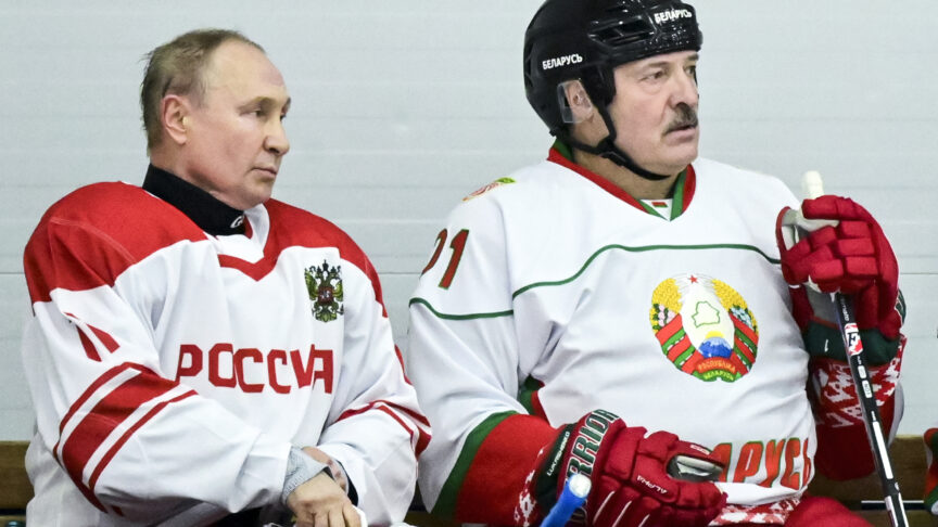Russian President Vladimir Putin, left, and Belarusian President Alexander Lukashenko take a pause during the Night Hockey League match following their talks in Strelna, outside St. Petersburg, Russia, Wednesday, Dec. 29, 2021. (Andrei Stasevich/BelTA Pool Photo via AP)