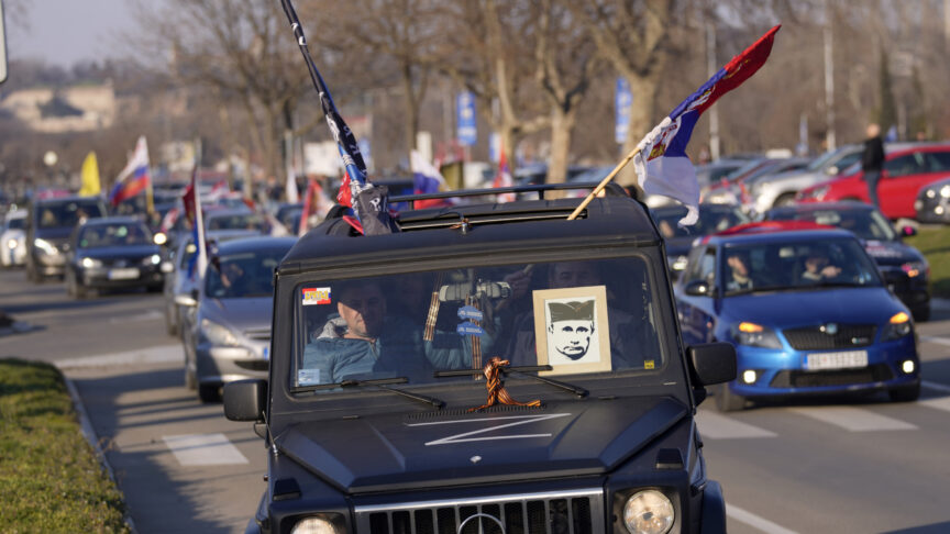 People drive cars and wave Russian and Serbian flags during a rally in support of Russia in Belgrade, Serbia, Sunday, March 13, 2022. Despite formally seeking EU membership, Serbia has refused to introduce international sanctions against its ally Russia. EU officials have repeatedly warned Serbia that it will have to align itself with the bloc’s foreign policies if it wants to join. (AP Photo/Darko Vojinovic)
