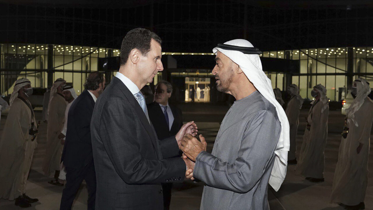 In this photo released by the official Facebook page of the Syrian Presidency, Syrian President Bashar Assad, left, speaks with Abu Dhabi’s Crown Prince, Sheikh Mohammed bin Zayed Al Nahyan, in Abu Dhabi, United Arab Emirates, Friday, March 18, 2022. Assad was in the United Arab Emirates on Friday, his office said, marking his first visit to an Arab country since Syria’s civil war erupted in 2011. (Syrian Presidency Facebook page via AP)