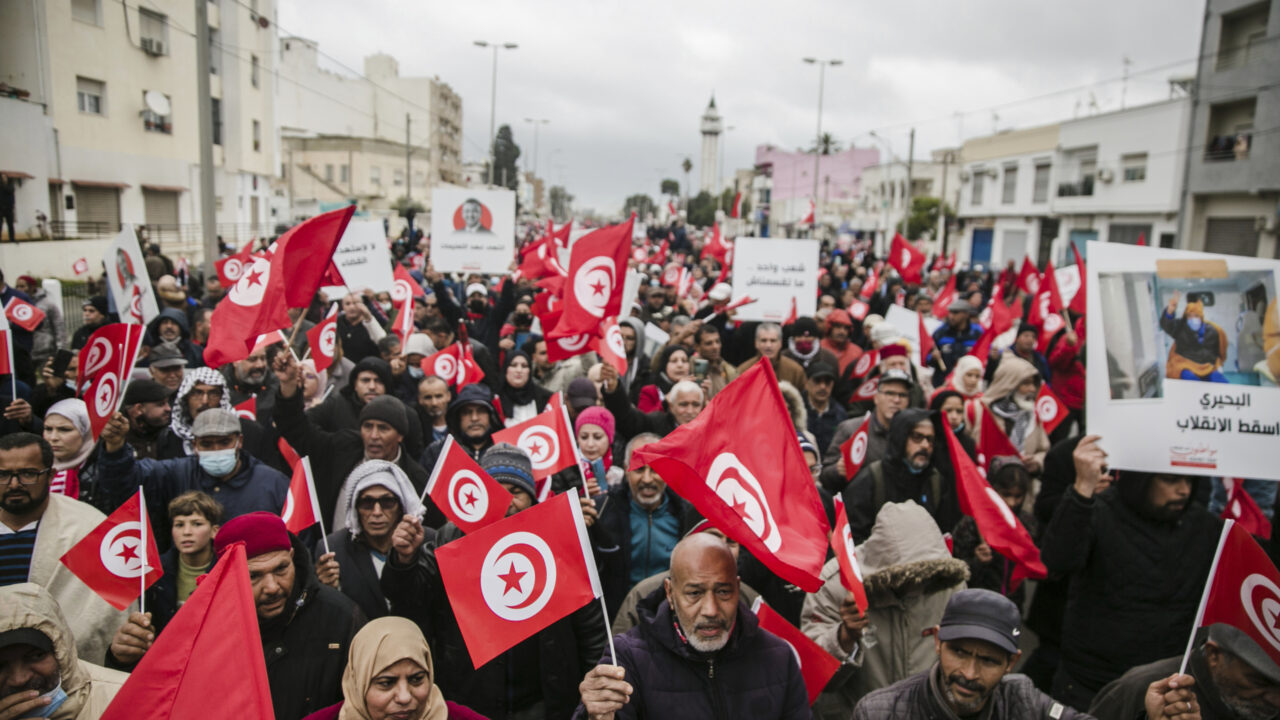 Tunisian demonstrators march with Tunisian flags during a rally against Tunisian President Kais Saied on the anniversary of Tunisia’s independence in Tunis, Tunisia, Sunday, March 20, 2022. (AP Photo/Hassene Dridi)