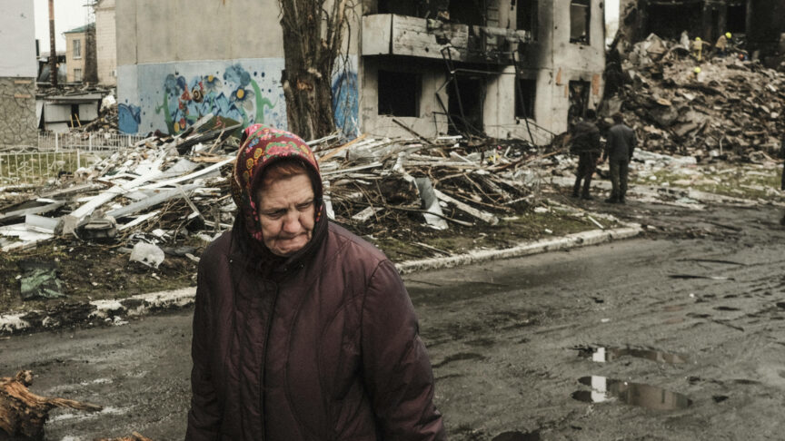 April 10, 2022, Borodyanka, Ukraine: A woman walks past a destroyed apartment building in Borodyanka as rescue workers continue operations to excavate the rubble for civilians buried beneath the debris. During the Russian encirclement of Kyiv many villages and suburbs outside of the city saw fierce fighting and brutal occupation by the invading Russians that resulted in numerous civilian casualties and reported war crimes throughout the region. Borodyanska, a village about 30 miles outside of Kyiv, saw airstrikes that buried an unknown number of residents in the basement of their apartment buildings. (Credit Image: © Matthew Hatcher/SOPA Images via ZUMA Press Wire