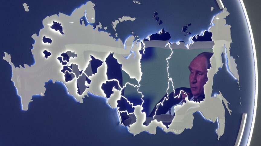 A screen showing Russian President Vladimir Putin is reflected in a stand displaying the map of Russia at the St. Petersburg International Economic Forum (SPIEF) in Saint Petersburg, Russia June 17, 2022. REUTERS/Anton Vaganov