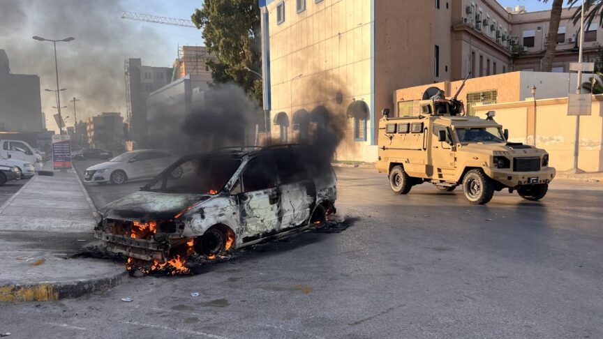 TRIPOLI, LIBYA – AUGUST 27: A wrecked vehicle burns at the Republic Street as clashes between rival militias spread to several neighborhoods in the Libyan capital Tripoli on August 27, 2022. Hazem Turkia / Anadolu Agency