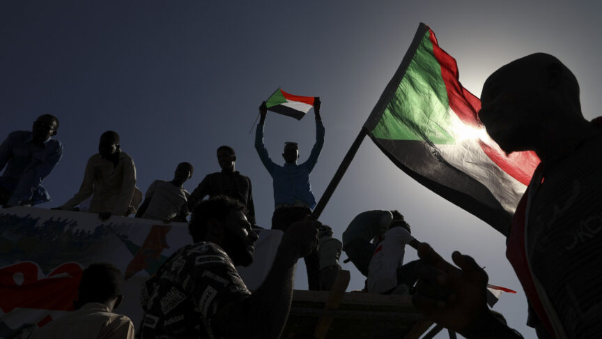 FILE – In this Nov. 19, 2019 file photo, people gather as they celebrate first anniversary of mass protests that led to the ouster of former president and longtime autocrat Omar al-Bashir. in Khartoum, Sudan. On Thursday, June 25, 2020, the United States, Germany and France have pledged hundreds of millions in aid to Sudan. The funds are intended to help the struggling African nation a year after pro-democracy protesters forced the removal of its long-time autocratic ruler, Omar al-Bashir.(AP Photo, File)