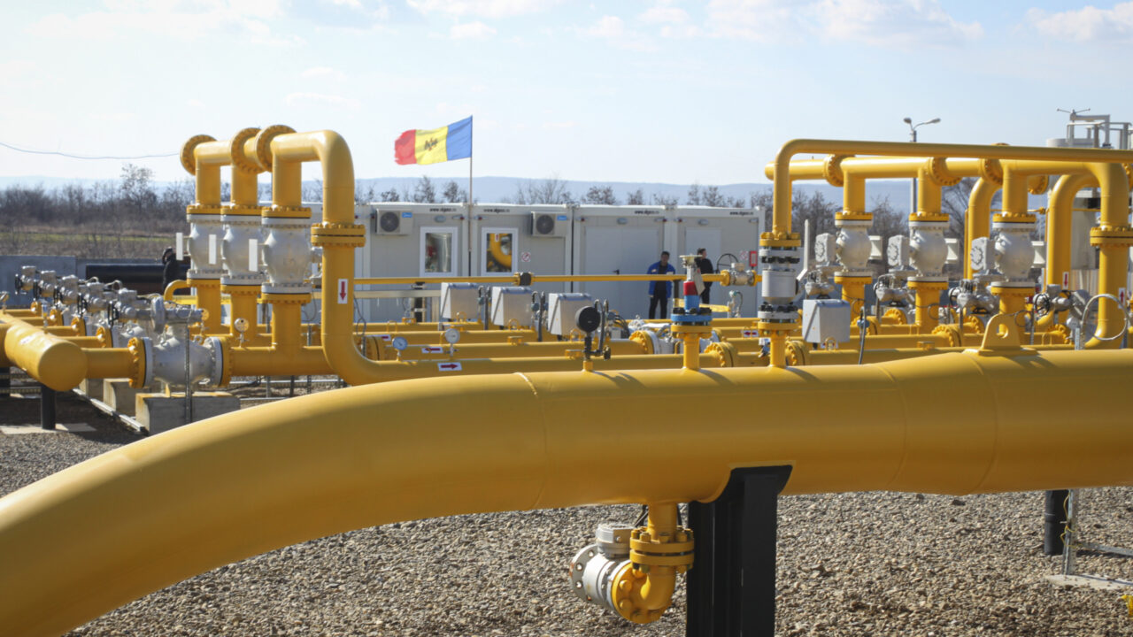 Men stand next to pipelines of the national natural gas distribution network outside Ungheni, Moldova, March 4, 2015. The country faces a looming natural gas supply shortage this winter after it failed to renew a long-term contract with Russia, as on Tuesday, Oct. 26, 2021, the former Soviet republic received a million cubic meters of gas from Poland, the first time in history it has turned to a non-Russian supplier, amid increasing geopolitical tensions as Moldova looks to forge closer ties with the European Union after for years being under strong Russian influence.(AP Photo/Aurel Obreja)