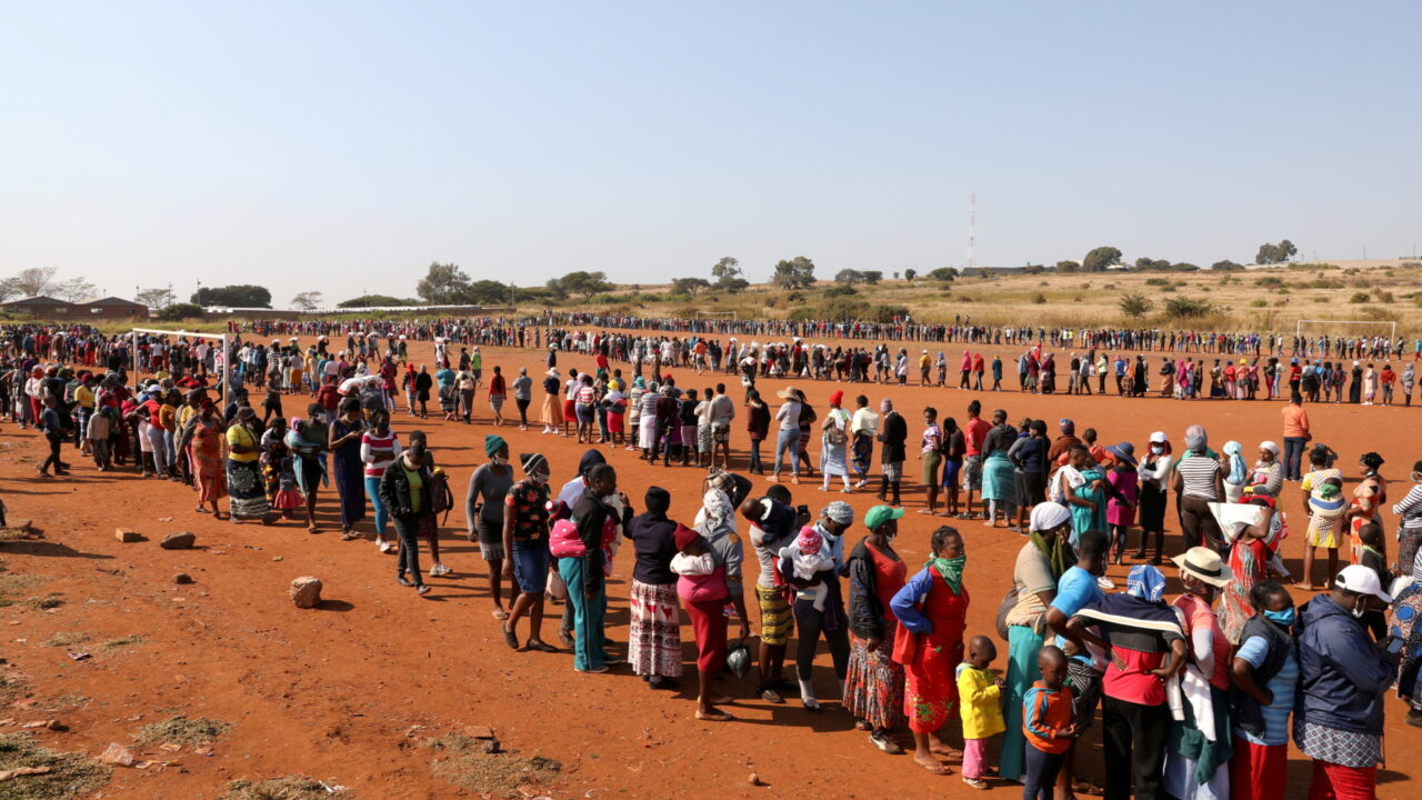 People stand in a queue to receive food aid, during the coronavirus disease (COVID-19) outbreak at the Itireleng informal settlement, near Laudium suburb in Pretoria, South Africa, May 20, 2020. REUTERS/Siphiwe Sibeko/File Photo TPX IMAGES OF THE DAY SEARCH “GLOBAL COVID-19” FOR THIS STORY. SEARCH “WIDER IMAGE” FOR ALL STORIES