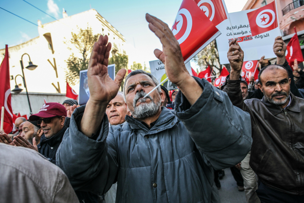 Demonstrators shout slogans while waving flags of Tunisia, during a demonstration held by the National Salvation Front opposition alliance, in Tunis, Tunisia, on March 5, 2023, to call for the release of arrested and detained opposition figures deemed critical of President Kais Saied.