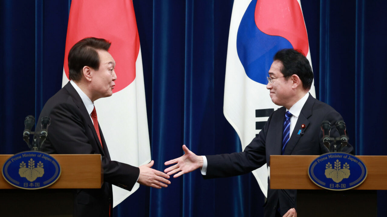 South Korean President Yoon Suk-yeol, left, and Japanese Prime Minister Fumio Kishida, right, shake hands at the prime minister’s office in Tokyo, Japan, Thursday, March 16, 2023. Kishida and Yoon agreed on Thursday to normalize relations between their countries that had been strained over wartime labor and other historical issues. (Jiji Press/Yasuyuki Kiriake)