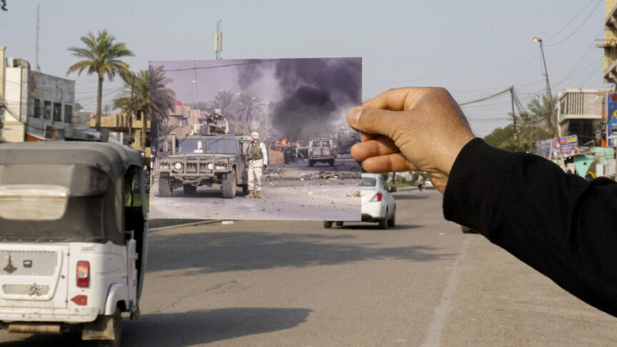 A photograph of U.S. troops securing the area after explosives went off in Baghdad’s Palestine Street Wednesday, Dec. 31, 2003, iis inserted into the scene at the same location Friday, March 24, 2023. 20 years after the U.S. led invasion on Iraq and subsequent war. (AP Photo/Hadi Mizban)