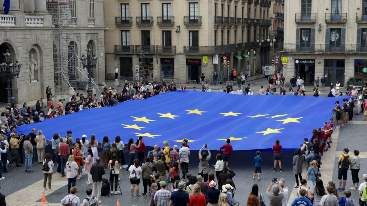 epa10617318 People carry a European flag during celebrations of Europe Day at the San Jaume square in Barcelona, Spain, 09 May 2023. A 22meter long flag has been displayed while 22 opera singers from Catalonia’s National Young Opera and from the Liceo Music School have performed the European anthem during a ceremony organized by the European Union headquarters in Barcelona. Photo: picture alliance/EPA/Quique Garcia