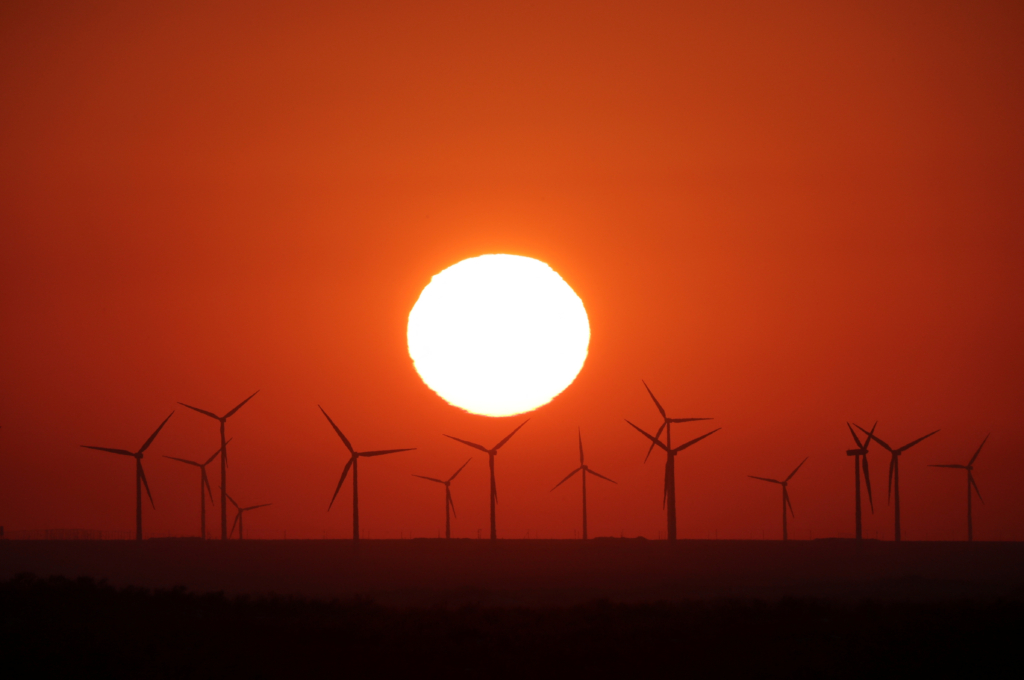 The sun sets behind a wind farm in the Almaty region, Kazakhstan