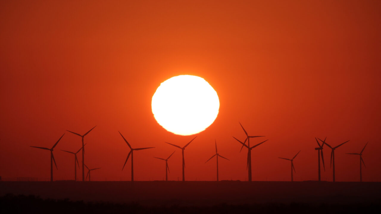 The sun sets behind a wind farm in the Almaty region, Kazakhstan