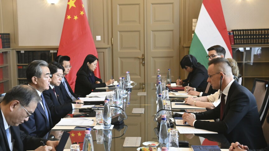China’s Foreign Minister Wang Yi, second left, and Hungarian Minister of Foreign Affairs and Trade Peter Szijjarto, right, talk during a meeting in Budapest, Hungary, Monday, Feb. 20, 2023. (Zoltan Mathe/MTI via AP)