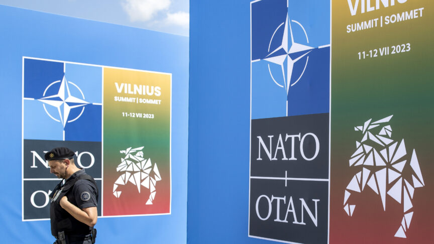 A security guard walks in front of a banner outside the venue of the NATO summit in Vilnius, Lithuania, Sunday, July 9, 2023. Russia’s war on Ukraine will top the agenda when U.S. President Joe Biden and his NATO counterparts meet in the Lithuanian capital Vilnius on Tuesday and Wednesday. (AP Photo/Mindaugas Kulbis)