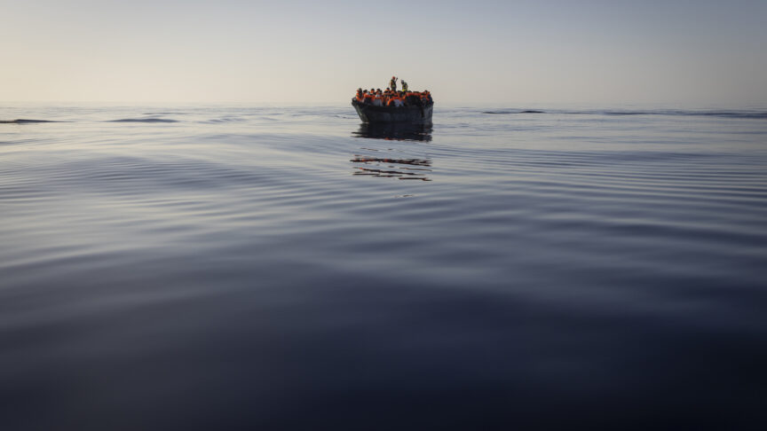 Migrants with life jackets provided by volunteers of the Ocean Viking, a migrant search and rescue ship run by NGOs SOS Mediterranee and the International Federation of Red Cross (IFCR), still sail in a wooden boat as they are being rescued, Aug. 27, 2022, in the Mediterranean sea. The back-to-back shipwrecks of migrant boats off Greece that left at least 22 people dead this week has once again put the spotlight on the dangers of the Mediterranean migration route to Europe.