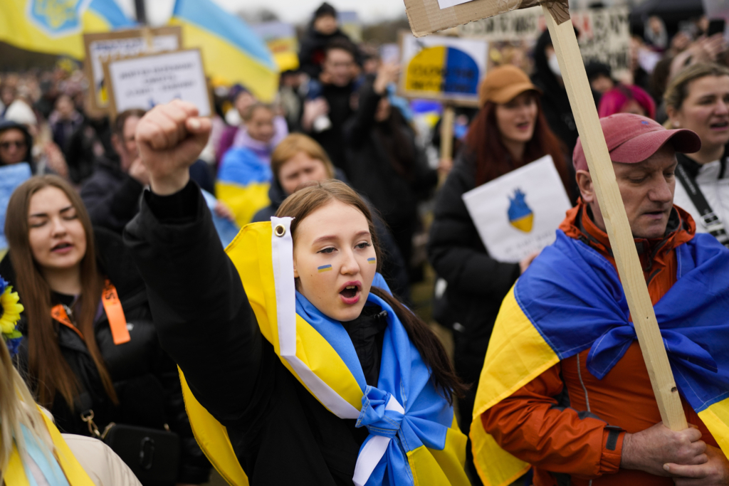 Protestors attend a demonstration against the Russian invasion on Ukraine and to demand the stoppage of energy trading with Russia, in front of the Reichstag building in Berlin, Germany, Wednesday, April 6, 2022.