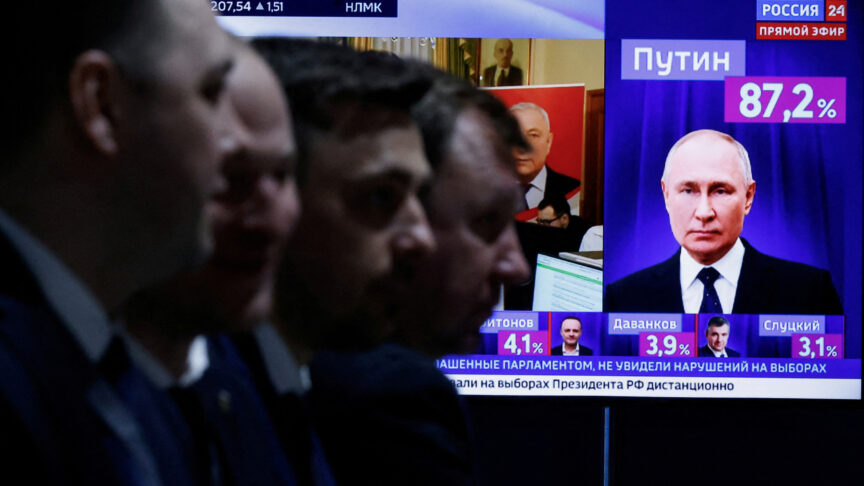 Men sit near a TV broadcasting news on the results of Russian presidential candidate and incumbent President Vladimir Putin, on the final day of the presidential election in Moscow, Russia, March 17, 2024. REUTERS/Maxim Shemetov TPX IMAGES OF THE DAY