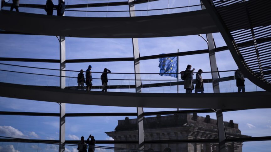 Visitors walk in front of a European Union flag inside the glass dome of the Reichstag Building, Germany’s parliament building, on a sunny winter day in Berlin, Sunday, Feb. 25, 2024. (AP Photo/Markus Schreiber)