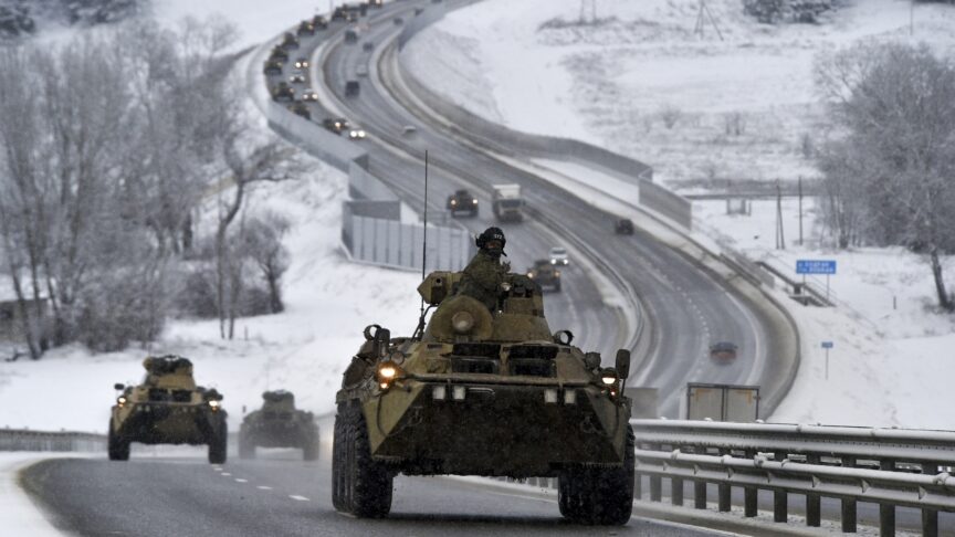 FILE – A convoy of Russian armored vehicles moves along a highway in Crimea, Tuesday, Jan. 18, 2022. Russia has concentrated an estimated 100,000 troops with tanks and other heavy weapons near Ukraine in what the West fears could be a prelude to an invasion. Germany’s refusal to join other NATO members in supplying Ukraine with weapons has frustrated allies and prompted some to question Berlin’s resolve in standing up to Russia. (AP Photo, File)