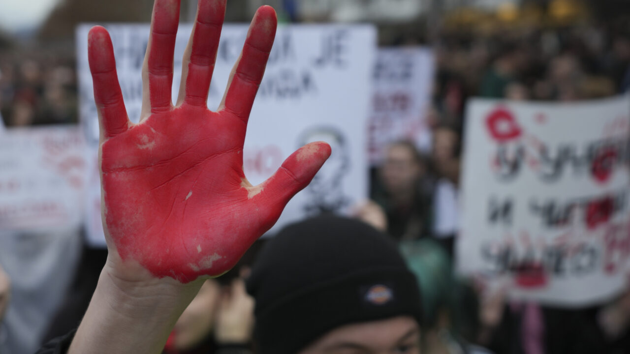 A man raises a red hand symbolizing the blood during a protest, a day after the assault on students was carried out by thugs with baseball bats, in Novi Sad, Serbia, Tuesday, Jan. 28, 2025. (AP Photo/Darko Vojinovic)