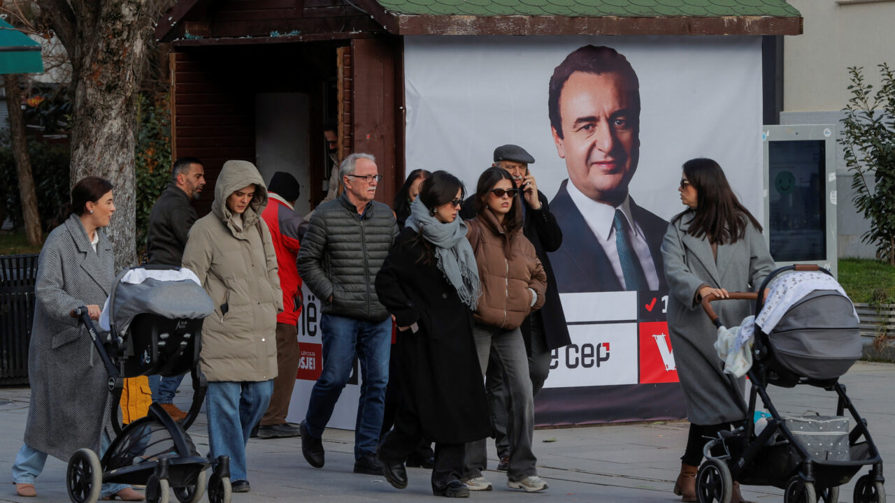 Pedestrians walk near a campaign poster for the upcoming parliamentary elections showing a portrait of Albin Kurti, Kosovo’s Prime Minister and leader of the Self-Determination party, in Pristina, Kosovo February 4, 2025. REUTERS/Valdrin Xhemaj