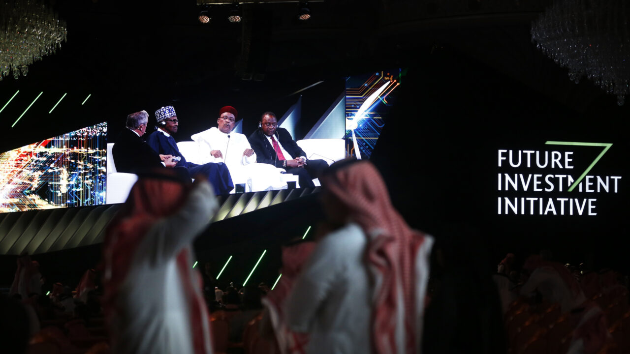 Participants watch a screen showing President Uhuru Kenyatta of Kenya, right, President Mahamadou Issoufou of Niger, center, and President Muhammadu Buhari of Nigeria, second left, attend a discussion panel during the Future Investment Initiative forum in Riyadh, Saudi Arabia, Wednesday, Oct. 30, 2019