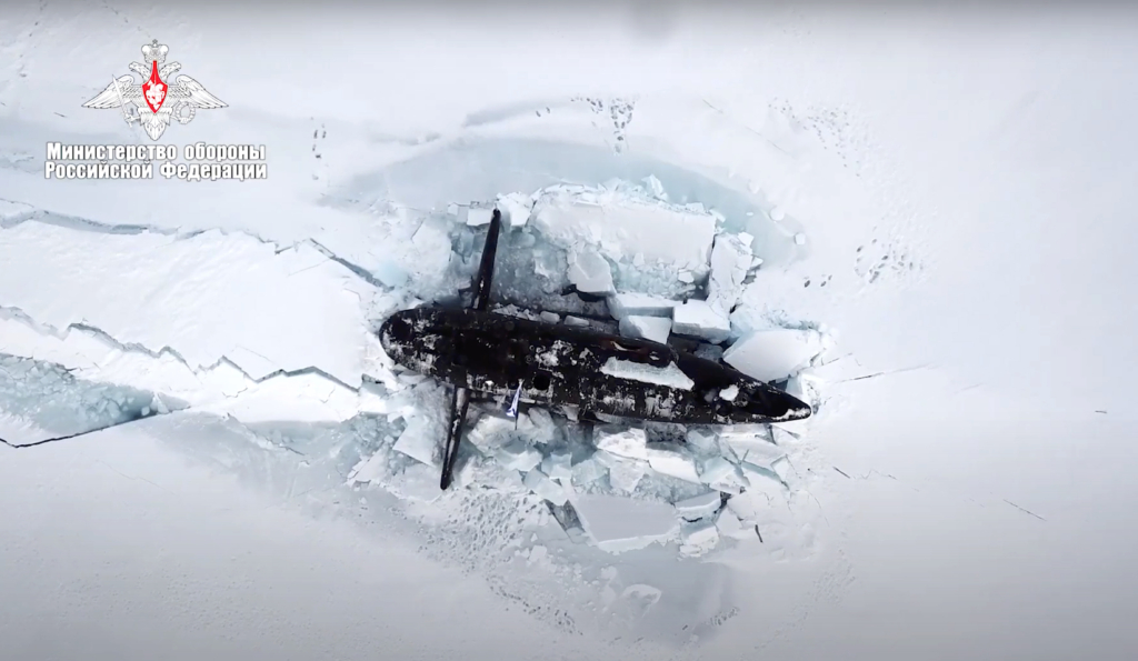 In this handout photo taken from a footage released by Russian Defense Ministry Press Service on March 26, 2021, a Russian nuclear submarine breaks through the Arctic ice during military drills at an unspecified location.