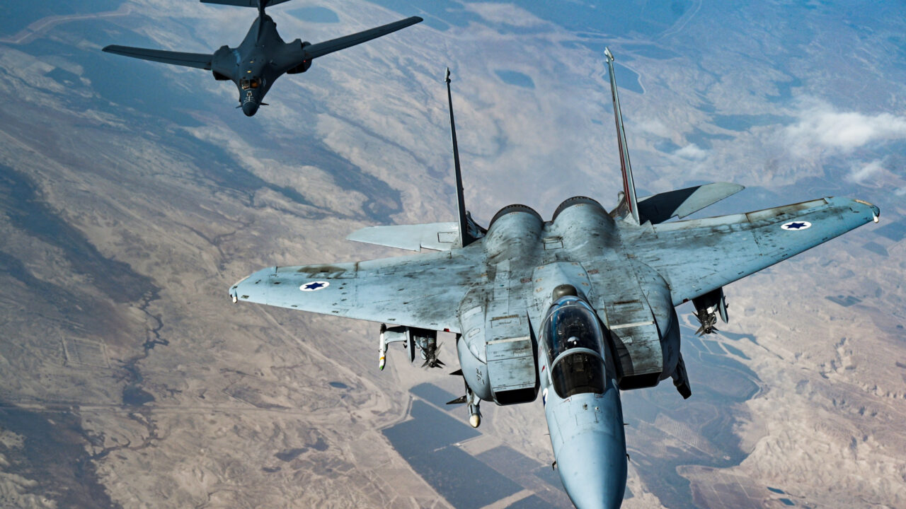 An Israeli Air Force F-15 Strike Eagle (foreground, right) flies in formation with a U.S. Air Force B-1B Lancer (background, left) over Israel