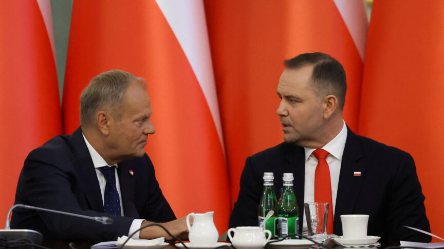 Poland's Prime Minister Donald Tusk speaks to President Karol Nawrocki during a Cabinet Council meeting led by the president at the Presidential Palace in Warsaw