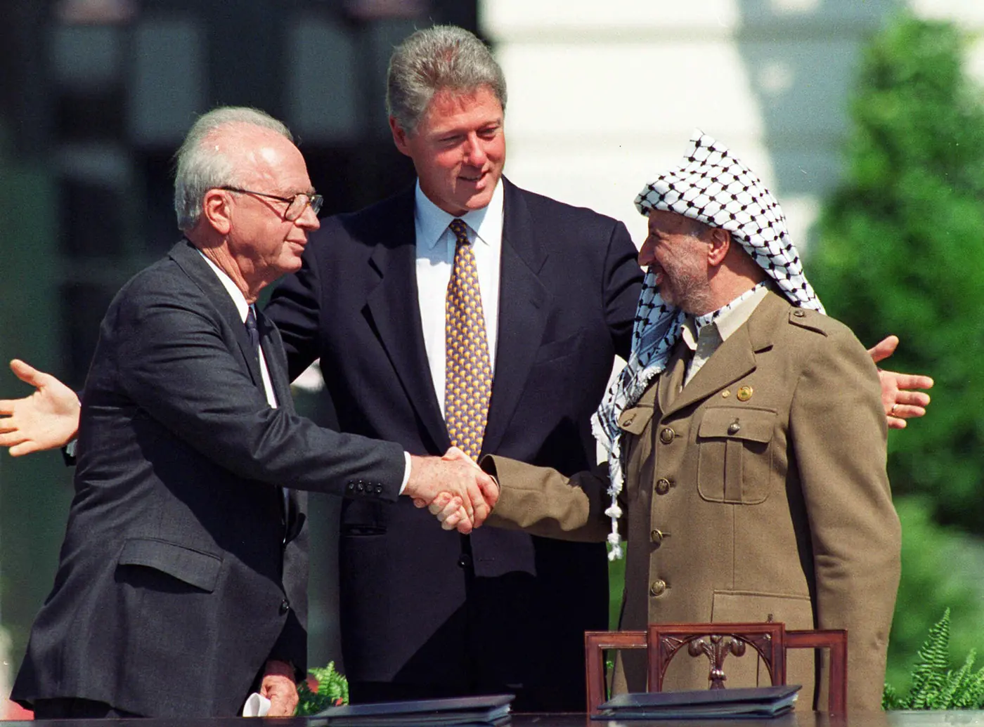 Israeli prime minister Yitzhak Rabin, left, and Palestinian leader Yasser Arafat shake hands to mark the signing of the peace accord between Israel and Palestine, in Washington, September 13th 1993