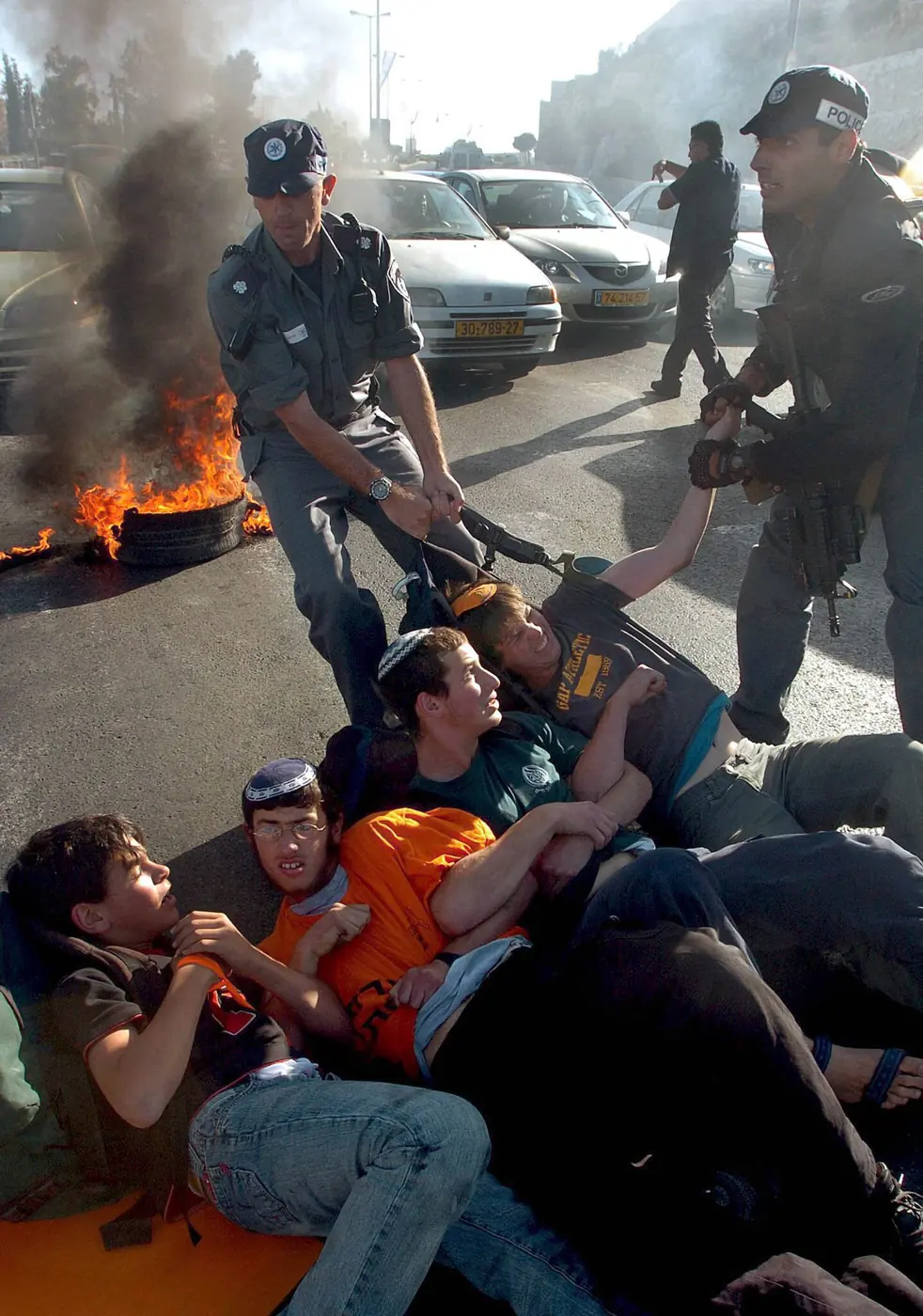 Israeli protestors blocking a road in Jerusalem on May 16th 2005 during a demonstration by Israelis against a “disengagement plan” that would have removed all Jews from settlements in the Gaza Strip and several West Bank settlements.