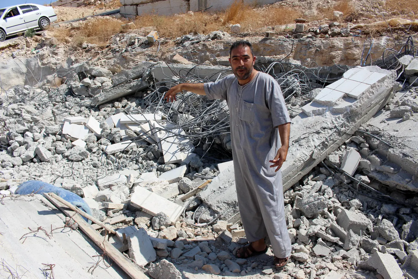 A Palestinian man inspects the remains of a mosque after it was demolished by Israeli security forces in the West Bank town of Mount Johar, south of Hebron on September 2nd 2019