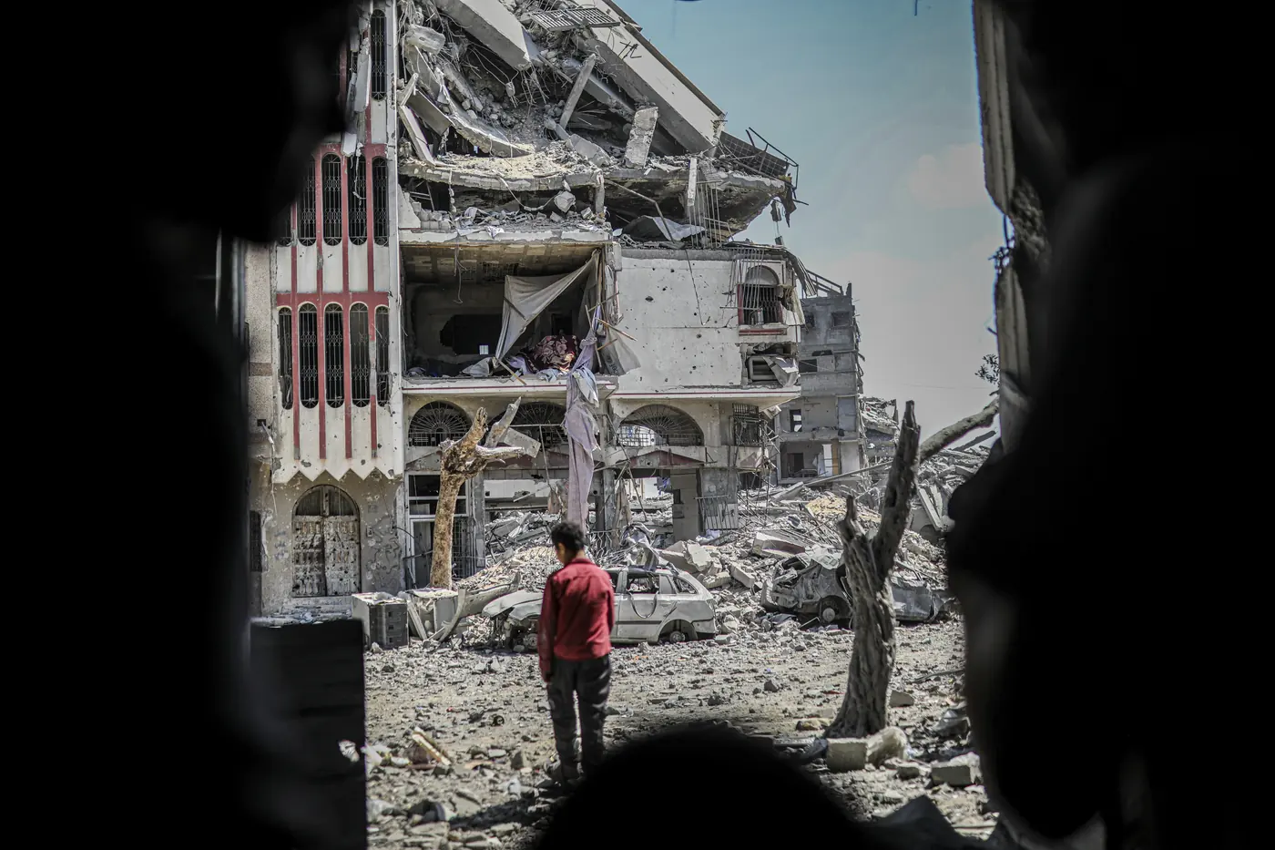 A boy stands facing a heavily damaged residential building in the Tuffah neighbourhood of Gaza City on September 22nd 2026