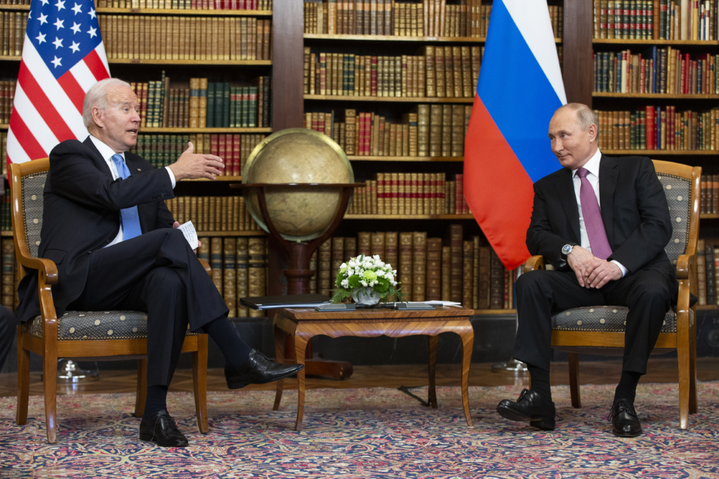 Presidents Biden and Putin are seated in a library during their summit in Geneva