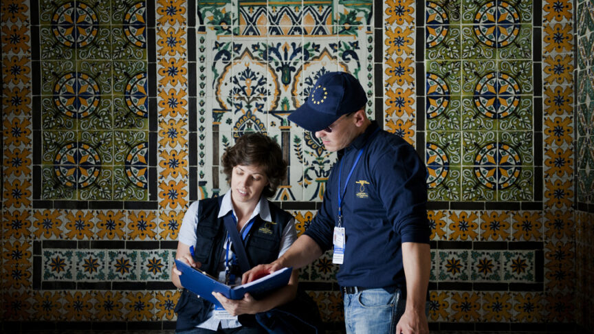 EU election observers in Tunisia stand in front of an ornate tile mosaic