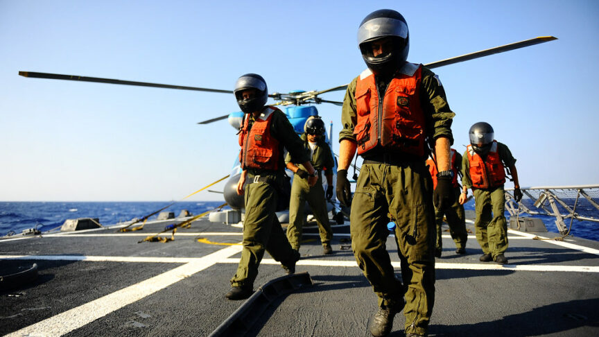 A Greek and Israeli helicopter crew step onto an aircraft carrier